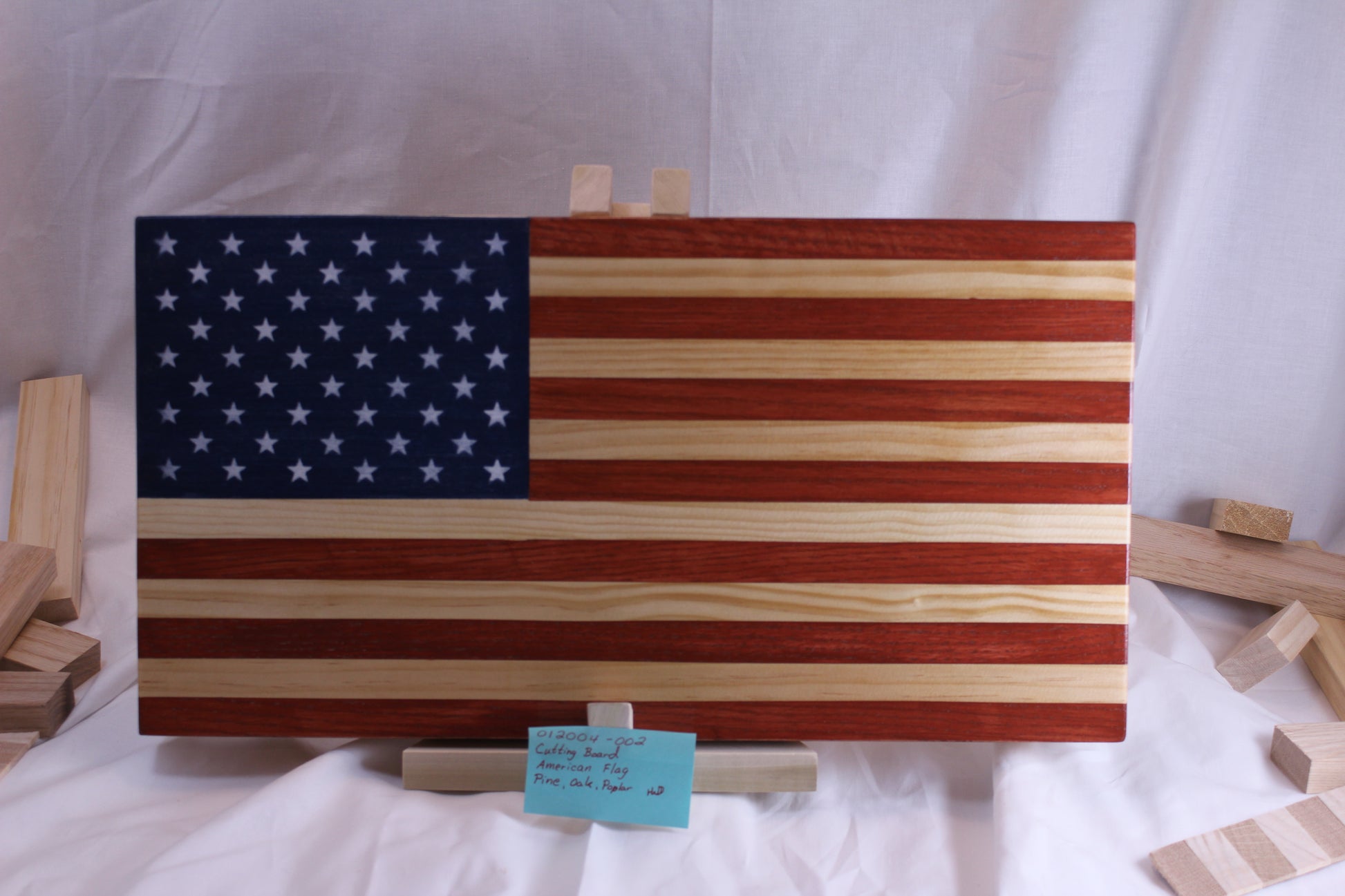 Front - American flag is colored with non-toxic water based stain allowing you to still see the beautiful wood grain. It has been coated with a food contact safe sealer.  
